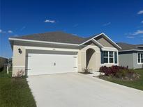 Charming single-story home with a two-car garage, well-maintained landscaping, and neutral color palette at 999 Brooklet Dr, Davenport, FL 33837