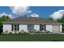 Charming single-story home featuring a classic design, lush landscaping, and a two-car garage at 521 Cardinal Dr, Poinciana, FL 34759