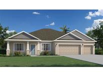 Charming single-story home with a three-car garage, well-manicured lawn, and welcoming curb appeal at 3556 Sw 128Th Pl, Ocala, FL 34473