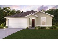 Charming single-story home boasts a two-car garage, well-manicured lawn, and inviting curb appeal at 2323 Oklahoma Dr, Sumterville, FL 33585