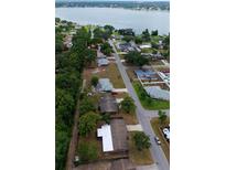 Expansive aerial view showcases neighborhood homes near the tranquil lake at 5801 Poinciana Ave, Lakeland, FL 33809