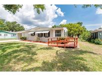 Charming single-story home featuring a front yard and wooden deck, perfect for relaxing outdoors at 760 Formosa Ave, Bartow, FL 33830