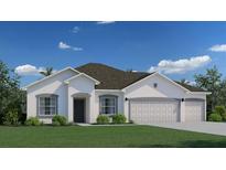 Charming single-story home featuring a three-car garage, stucco walls, and well-manicured lawn against a bright blue sky at 5069 Sw 116Th Pl, Ocala, FL 34476