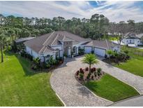 Luxury home with circular driveway, landscaped yard, and tile roof at 109 La Toscana Rotonda, Ormond Beach, FL 32174