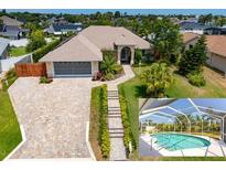 Landscaped home with a brick paved driveway and screened-in pool at 3 Seabridge Dr, Ormond Beach, FL 32176