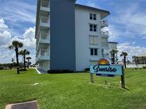 Sunrise Condominiums with lush green lawns and palm trees offer a relaxing coastal lifestyle at 2294 Ocean Shore Blvd # 1020, Ormond Beach, FL 32176