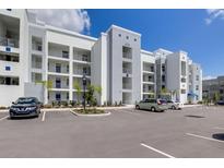 Modern apartment building with parking and landscaped grounds at 4741 Clock Tower Dr # 105, Kissimmee, FL 34746