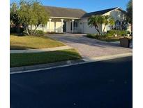 Single-story house with a paved driveway and landscaping at 130 Prima Dr, Kissimmee, FL 34759