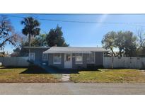 Gray house with a white door, and small yard at 623 Unabelle Ave, Holly Hill, FL 32117