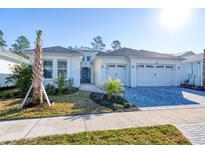 Two-story home with a three-car garage and attractive landscaping at 707 Hang Loose Way, Daytona Beach, FL 32124