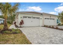 Exterior view of a two-car garage with paver driveway at 757 Coral Reef Way, Daytona Beach, FL 32124