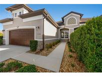 Two-story house with walkway, landscaping, and brown garage door at 1510 Kinnard Cir, Ormond Beach, FL 32174