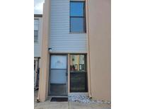 Exterior view of a light beige building with a white door and window at 5500 Ocean Shore Blvd # Ut61, Ormond Beach, FL 32176