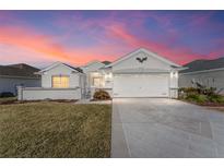 Inviting one-story home with a landscaped yard and two-car garage at 11977 Se 91St Cir, Summerfield, FL 34491