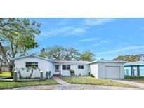 White single story home with a detached garage and well-manicured lawn at 142 Seton Trl, Ormond Beach, FL 32176