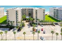 Oceanfront condo building with parking and lush landscaping at 4565 S Atlantic Ave # 5411, Ponce Inlet, FL 32127