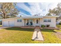 Cute ranch home with attached two-car garage and landscaped lawn at 105 Park Cir, Daytona Beach, FL 32117