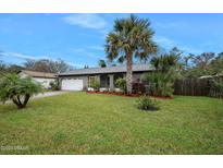 Inviting home exterior featuring a spacious lawn and lush landscaping at 41 Laurel Oaks Cir, Ormond Beach, FL 32174