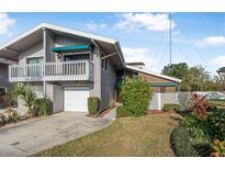 Two-story townhome with attached garage and balcony at 135 Lagoon Ct, New Smyrna Beach, FL 32169