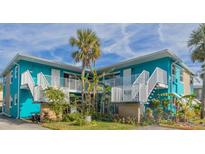 Charming teal building with balconies and lush landscaping at 2596 Tulane Ave # 4, Daytona Beach, FL 32118