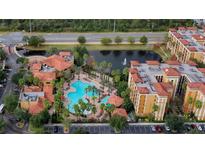 Beautiful aerial view of resort amenities including a pool, pond and clubhouse at 12544 Floridays Resort Dr # 507-B, Orlando, FL 32821