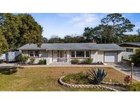 Charming single-story home with well-maintained front yard and an attached one-car garage at 1705 Cordova Ave, Daytona Beach, FL 32117