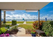 Scenic patio with lush landscaping, offering serene views of the waterway and community at 118 S Halifax Ave # 103, Daytona Beach, FL 32118