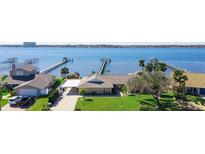 Waterfront home with private boat docks, lush landscaping, and a convenient carport at 2912 River Point Dr, Daytona Beach, FL 32118