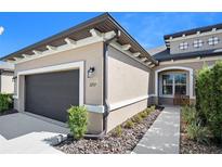 Stylish one-story home showcasing modern architectural elements, neutral color scheme, and well-maintained landscaping at 3257 Bailey Ann Dr, Ormond Beach, FL 32174