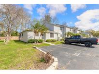 Well-maintained condo with tidy lawn, mature landscaping, and convenient parking at 1101 Deer Springs Rd, Port Orange, FL 32129