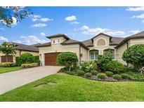 Inviting single-story home featuring lush landscaping, a two-car garage, and a neutral color palette at 3160 Bailey Ann Dr, Ormond Beach, FL 32174