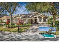 Charming single-story home with lush landscaping, brick driveway, and attached two-car garage at 5 Captiva At Lionspaw, Daytona Beach, FL 32124