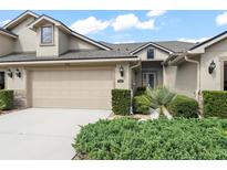 Charming home exterior featuring a two-car garage and well-maintained landscaping at 1320 Hansberry Ln, Ormond Beach, FL 32174