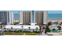 View of beachfront condos with balconies overlooking the ocean and beach at 1133 Ocean Shore Blvd # 302, Ormond Beach, FL 32176