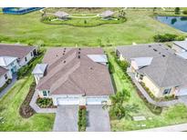 An aerial view showcases this home's landscaping, and the community pool, lake and cabana amenities at 251 Island Breeze Ave, Daytona Beach, FL 32124