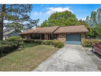 Charming single-story brick home featuring a well-maintained front yard and attached garage at 3385 Ne 44Th Pl, Ocala, FL 34479