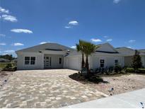 A beautifully built new construction home featuring a brick driveway and a well manicured front lawn at 1010 Megano Blvd, Deland, FL 32724