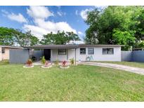 Charming single-story home featuring a well-manicured lawn, updated exterior paint, and a covered entry way at 220 Woodmere Blvd, Sanford, FL 32773