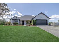 Charming one-story home with a lush green lawn and a two-car garage at 1060 Still Rd, Pierson, FL 32180