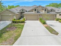 Beautiful townhomes featuring attached garages, manicured landscaping and neutral color palette at 1128 Hansberry Ct, Ormond Beach, FL 32174