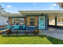 Charming home with a blue exterior, inviting front porch, and well-maintained lawn at 48 Rosewood Ave, Ormond Beach, FL 32174