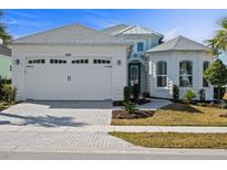 Charming single-Gathering home featuring a white exterior, two-car garage, and meticulously manicured landscaping at 540 Good Life Way, Daytona Beach, FL 32124