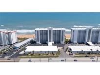 Expansive aerial view of beachfront condos offering stunning ocean views and convenient beach access at 1155 Ocean Shore Blvd # 702, Ormond Beach, FL 32176