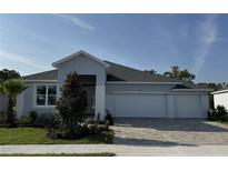 Charming single-story home boasts a three-car garage and beautifully landscaped front yard at 1689 Lake Reserve Dr, Deland, FL 32724