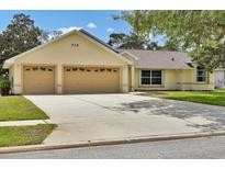 Charming one-story home with a spacious driveway, attached two-car garage, and well-manicured lawn at 518 Moon Rise Dr, Port Orange, FL 32127