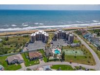 Oceanfront condo complex with amenities like a pool, tennis court, and private beach access, showcasing coastal living at 3370 Ocean Shore Blvd # 205-B, Ormond Beach, FL 32176