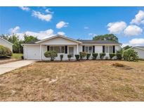 Charming single-story home with a well-maintained lawn and mature landscaping at 8720 Sw 108Th Ln, Ocala, FL 34481