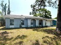 Single story home with a front yard, archway, and attached one-car garage at 1355 Dexter E Dr, Port Orange, FL 32129