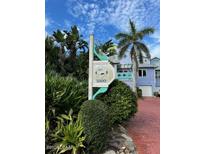 Barrier Island community sign with tropical landscaping and colorful coastal homes in the background at 3000 Ocean Shore Blvd # 150, Ormond Beach, FL 32176