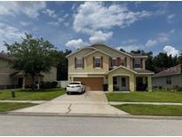 Charming two-story home featuring a two-car garage and a well-manicured lawn at 5 Cantilever Ct, Ormond Beach, FL 32174